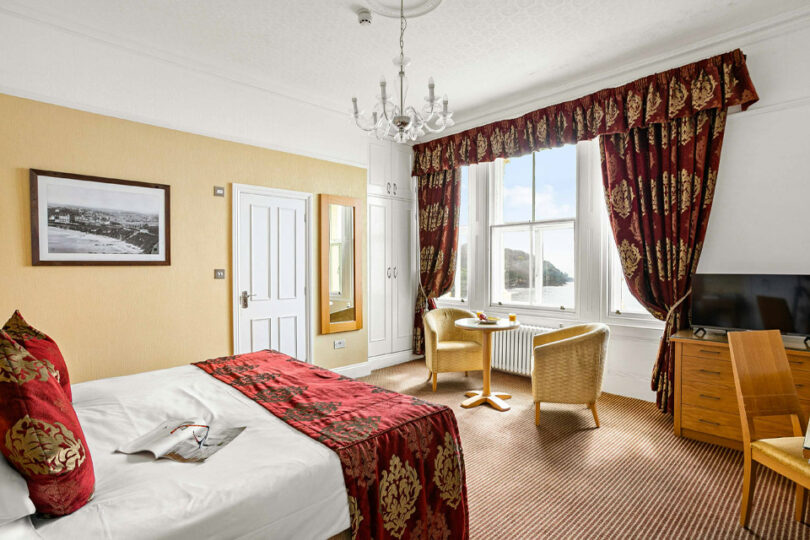 The executive sea view room with a large bed facing out of the window to sea
